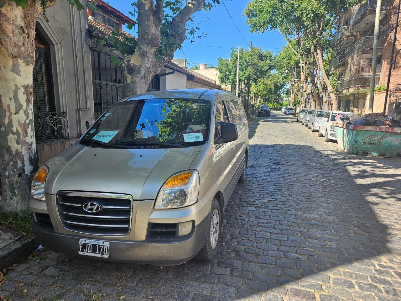 Van de Vamos Traslados estacionada en una calle empedrada de la ciudad